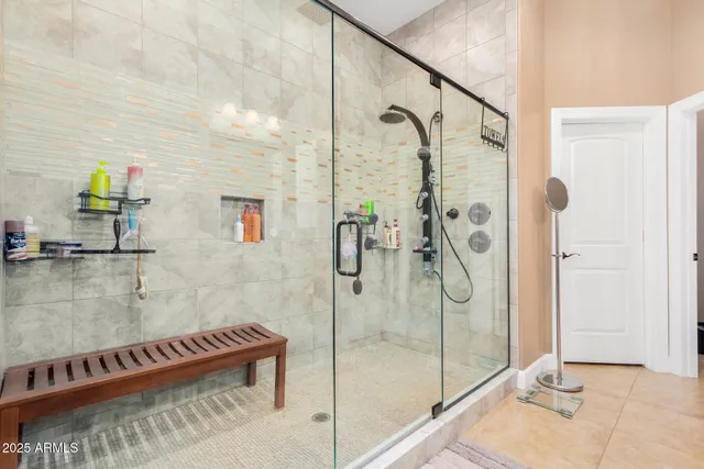 a bathroom with a glass shower door and a mirror