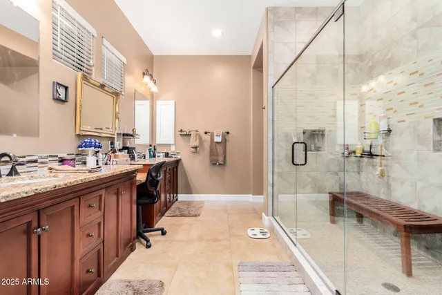 a spacious bathroom with a double vanity sink a mirror and shower