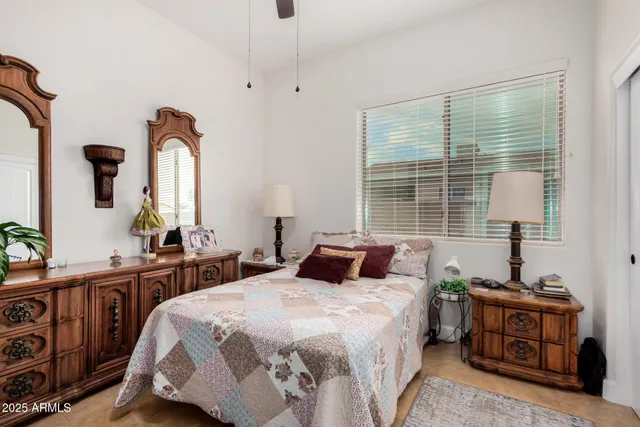 a bedroom with a bed a dresser and a window