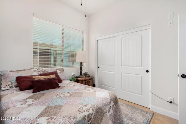 a bedroom with a bed and window