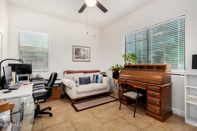 a livingroom with workspace and a window