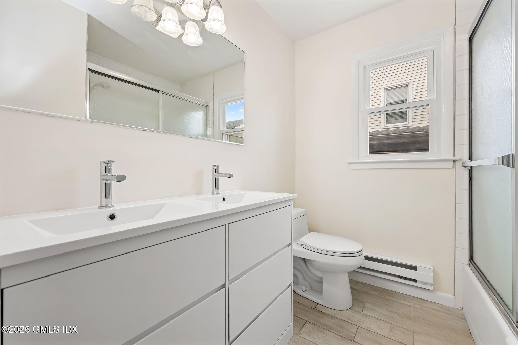 2 Grange Street Greenwich, CT 06830 - Photo 13 of 31 a bathroom with a toilet sink and mirror