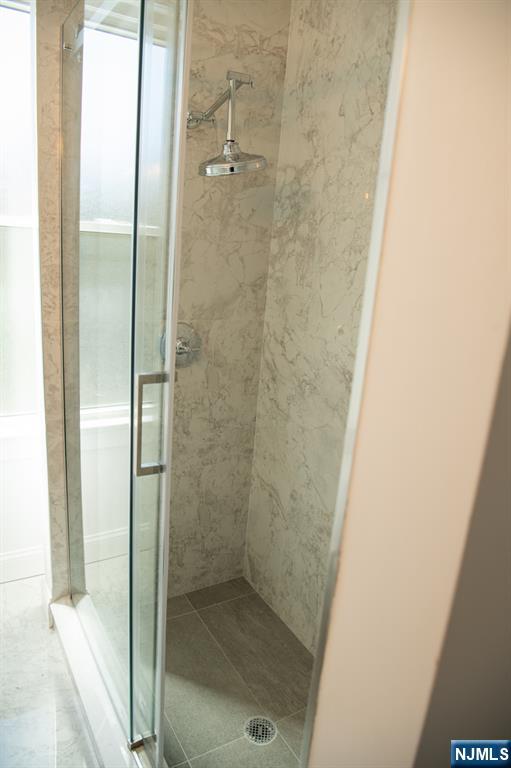 46 Garden Place, Unit 2 Edgewater, NJ 07020 - Photo 19 of 30 a bathroom with a glass shower door