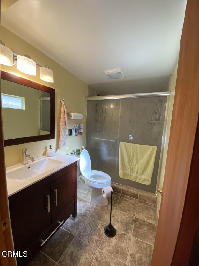 10444 Tujunga Canyon Boulevard Tujunga, CA 91042 - Photo 8 of 10 a bathroom with a sink a toilet and mirror