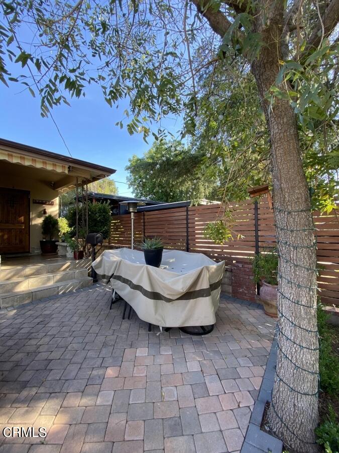 10444 Tujunga Canyon Boulevard Tujunga, CA 91042 - Photo 10 of 10 a view of a patio with table and chairs potted plants and a large tree