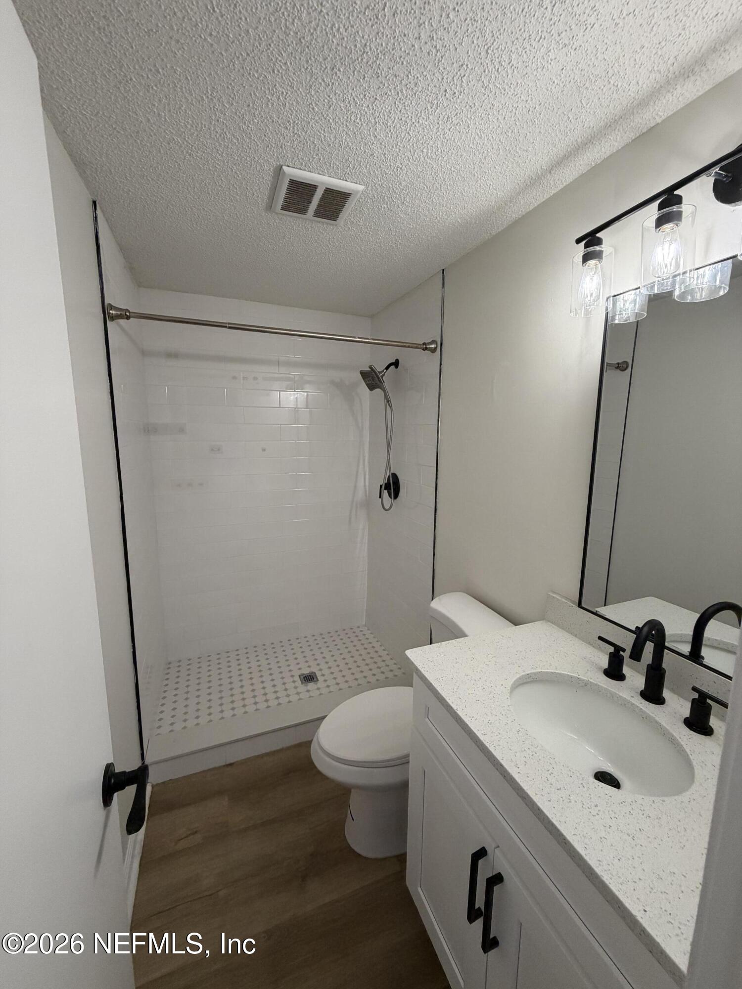 7539 Walden Road Jacksonville, FL 32244 - Photo 10 of 18 a bathroom with a sink a toilet and a mirror