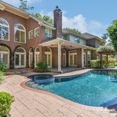 a front view of a house with swimming pool having outdoor seating