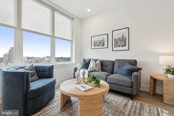a living room with furniture and a large window