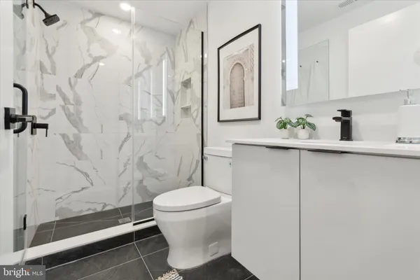 a bathroom with a toilet sink and shower