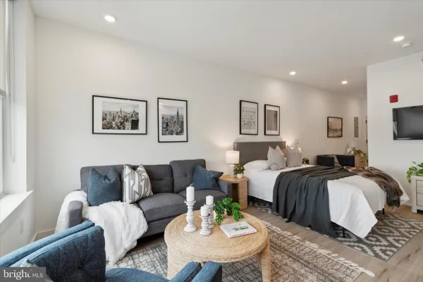 a spacious bedroom with a bed a couch and a window