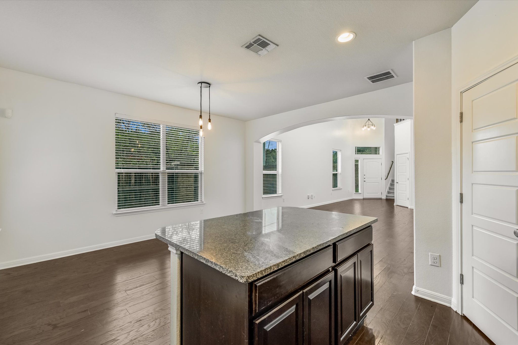 7709 Menchaca Road, Unit 1 Austin, TX 78745 - Photo 29 of 29 Desirable open floor plan with kitchen open to dining and living. Granite countertops, stainless steel appliances, pantry, center island with breakfast bar seating, and hardwood floors.