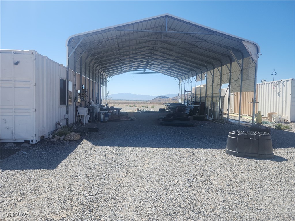 2311 West Mae Road Pahrump, NV 89060 - Photo 23 of 24 View of parking / parking lot featuring a mountain view, a carport, and driveway