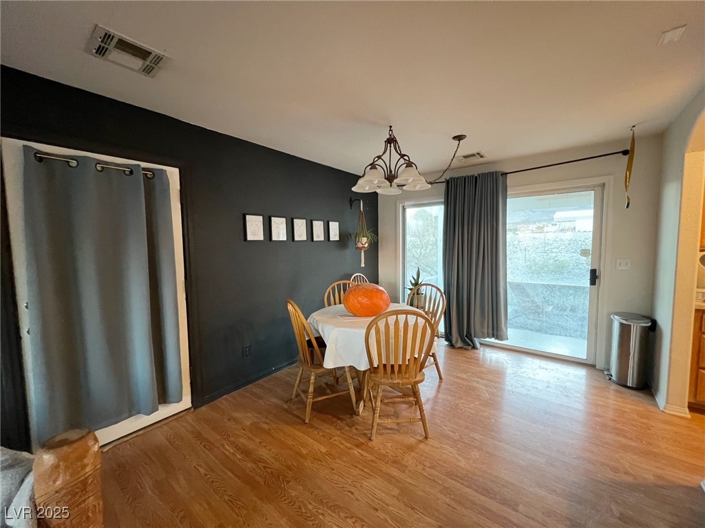 2311 West Mae Road Pahrump, NV 89060 - Photo 3 of 24 Dining area featuring light wood-type flooring and a chandelier