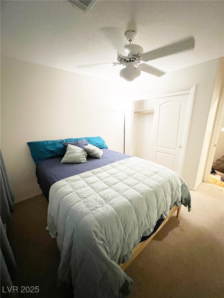 2311 West Mae Road Pahrump, NV 89060 - Photo 9 of 24 Bedroom featuring carpet flooring, ceiling fan, and a closet