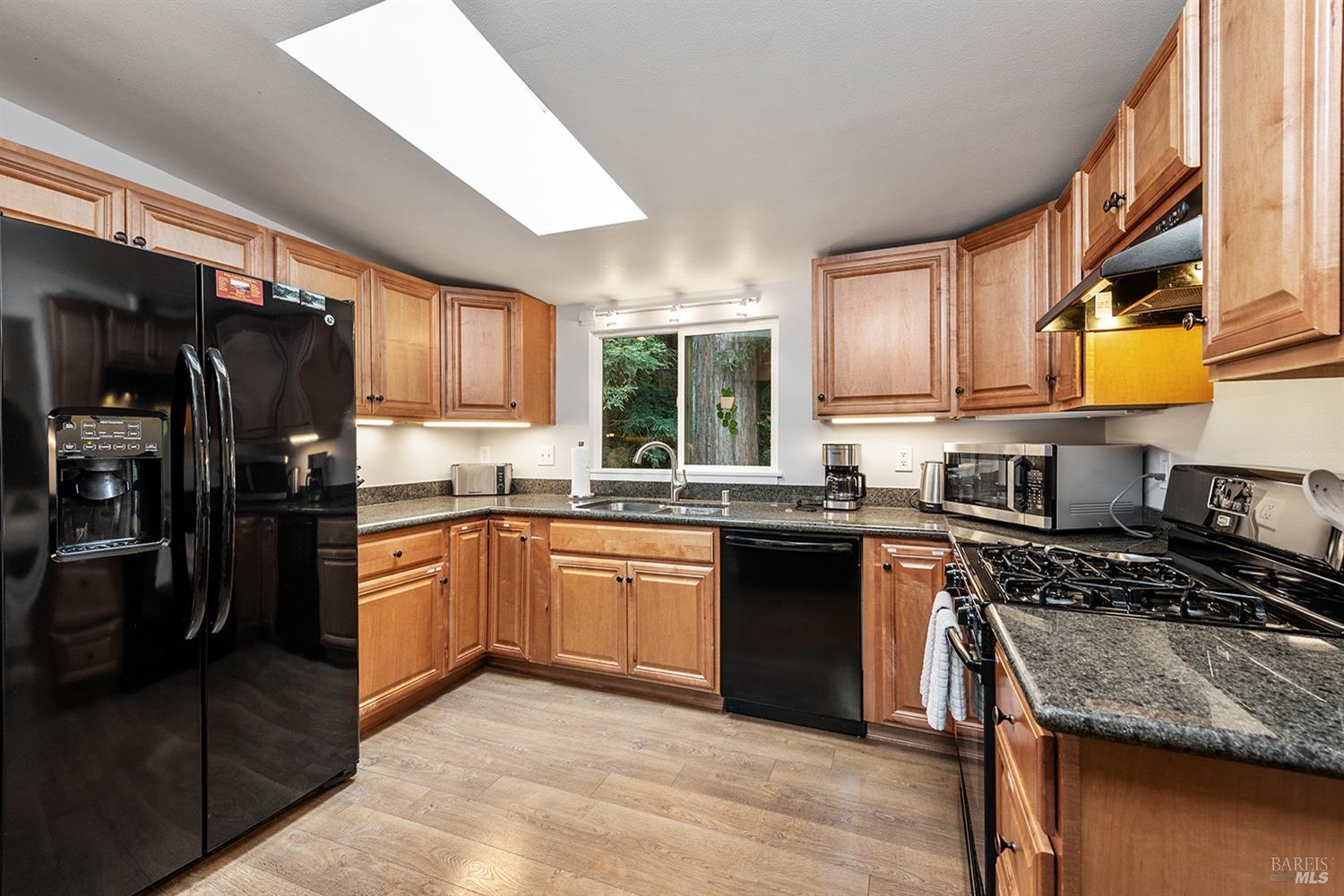 10680 Old River Road Forestville, CA 95436 - Photo 13 of 37 a kitchen with stainless steel appliances granite countertop a stove sink refrigerator and cabinets