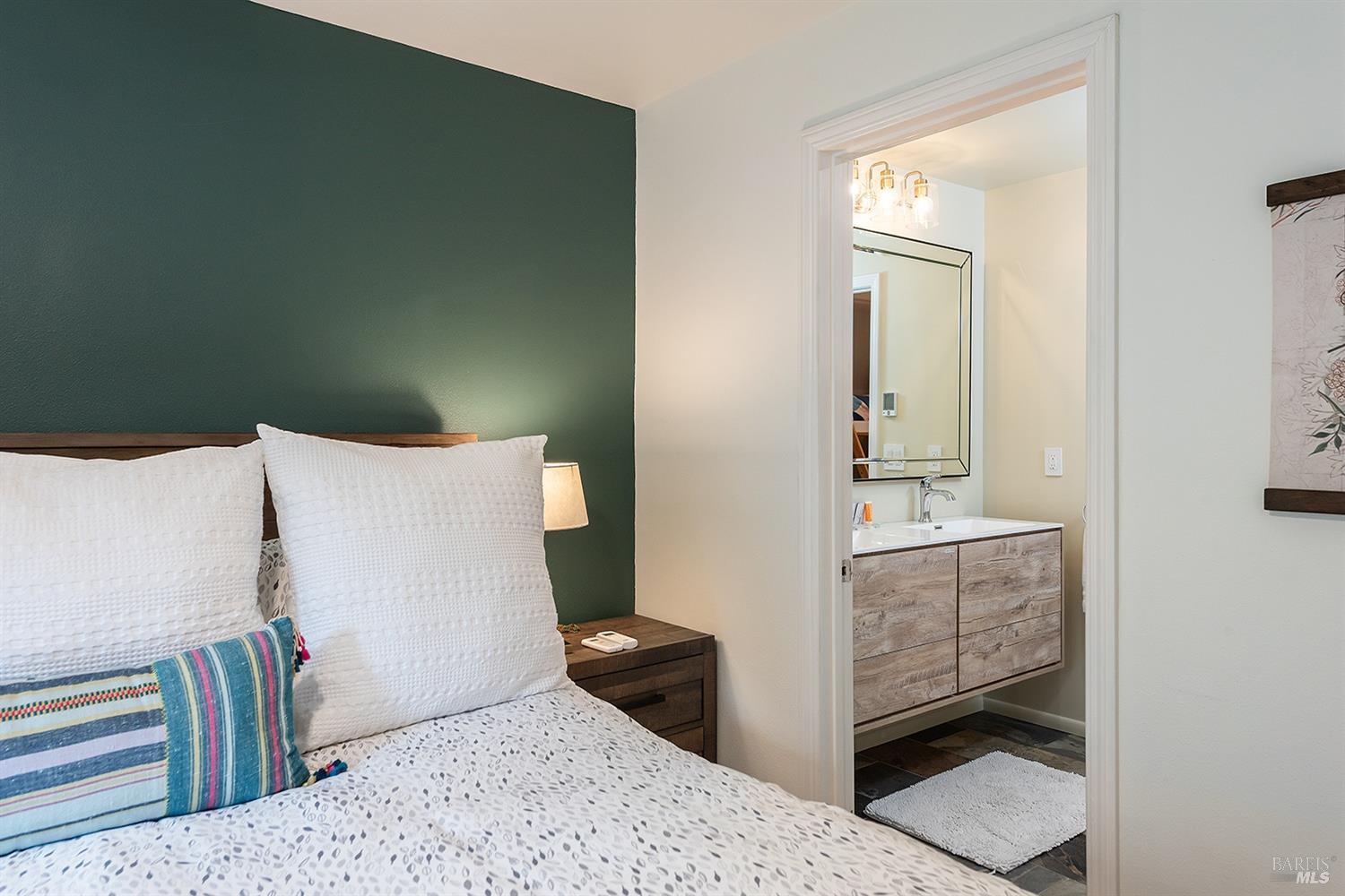 10680 Old River Road Forestville, CA 95436 - Photo 20 of 37 a bedroom with a bed and wooden floor