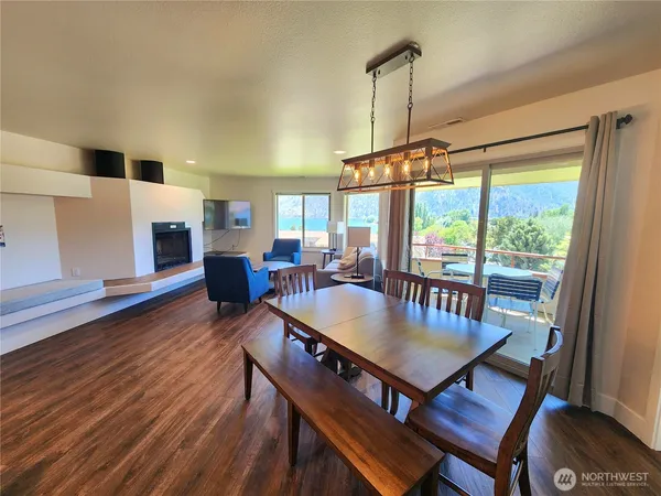 a dining room with furniture window and wooden floor
