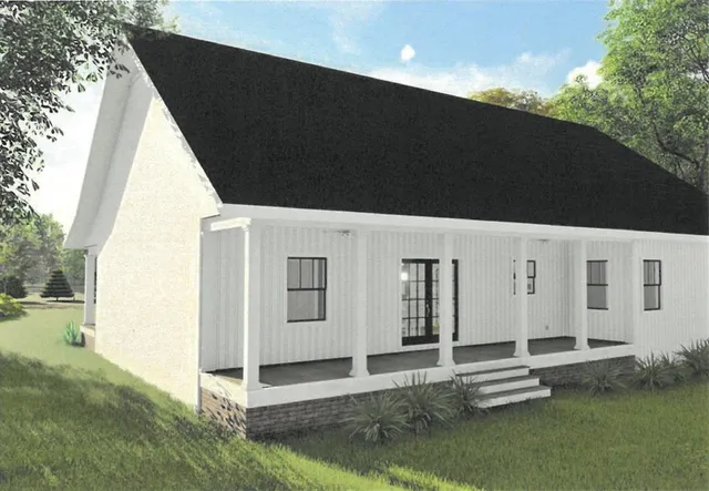 a backyard of a house with table and chairs