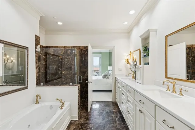 a bathroom with a tub sink and mirror