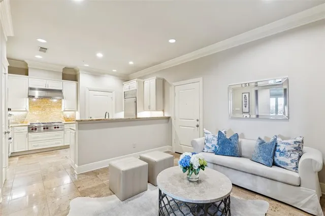 a living room with kitchen island furniture and a kitchen view