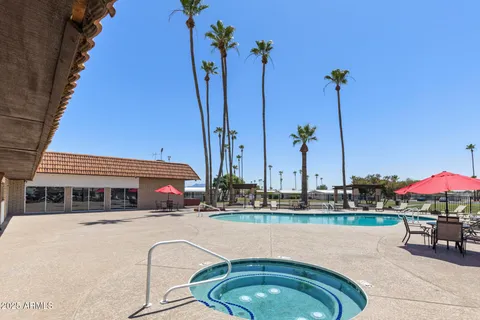 a roof deck with table and chairs under an umbrella