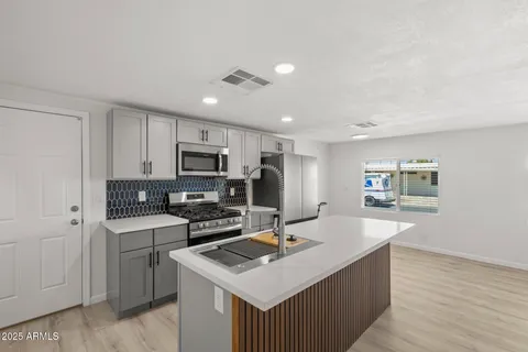 a kitchen with a sink stove and refrigerator