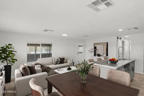 a living room with furniture and flowers