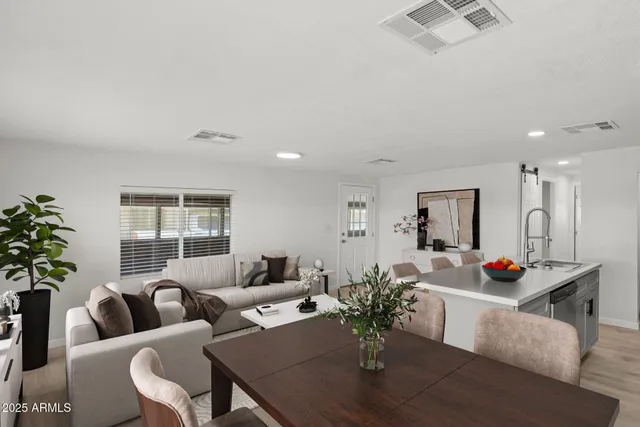 a living room with furniture and flowers