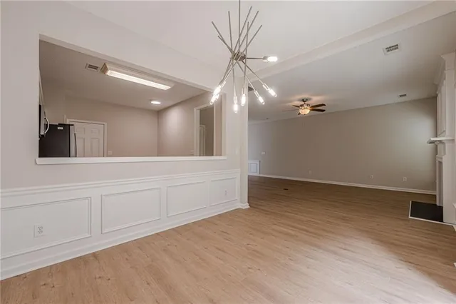 a view of a kitchen with a sink cabinets and wooden floor