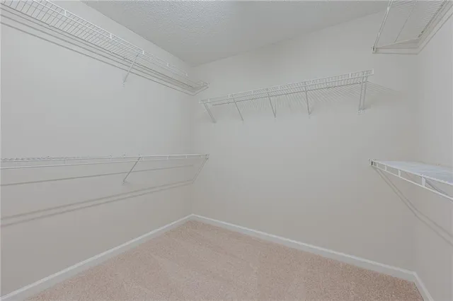 an empty room with closet and a ceiling fan