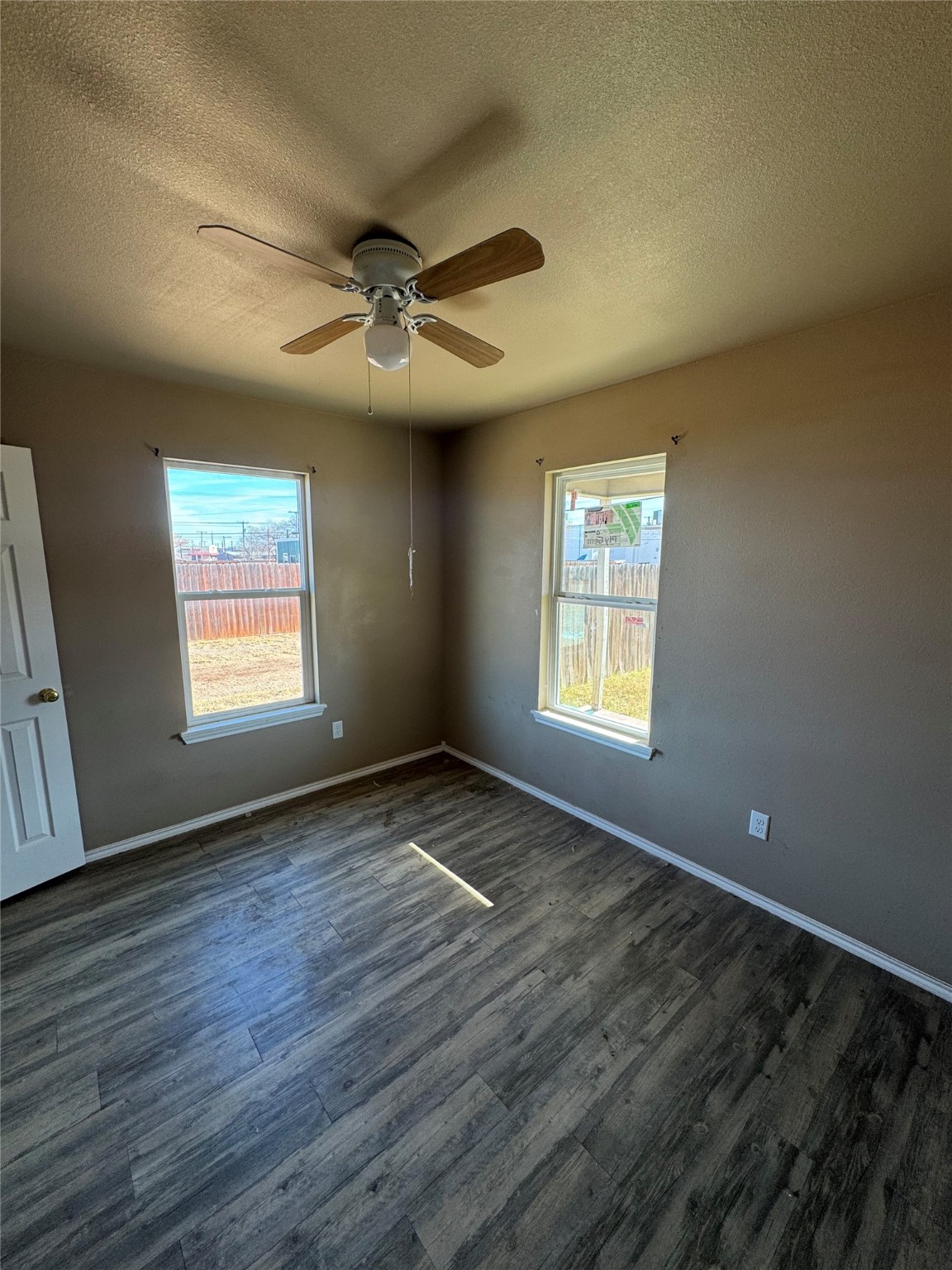 507 49th Street Lubbock, TX 79404 - Photo 21 of 50 a view of an empty room with wooden floor and a window