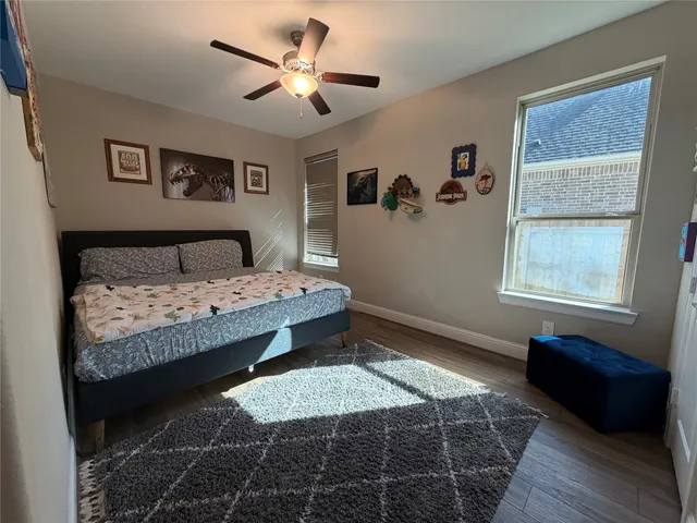 a bedroom with a large bed and a window