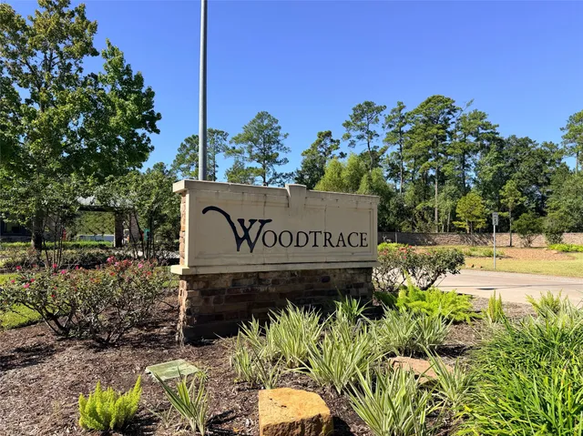 a sign that is sitting in front of flowers