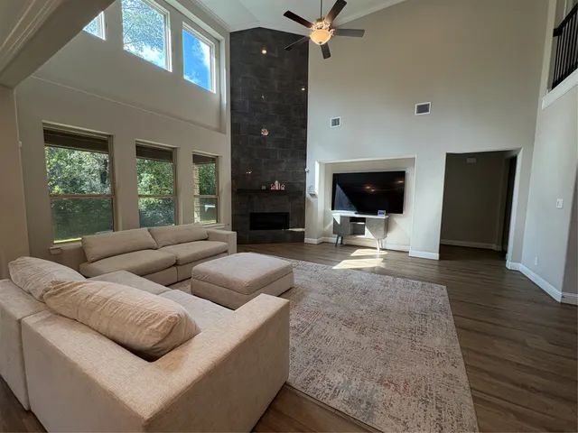 a living room with furniture window and flat screen tv