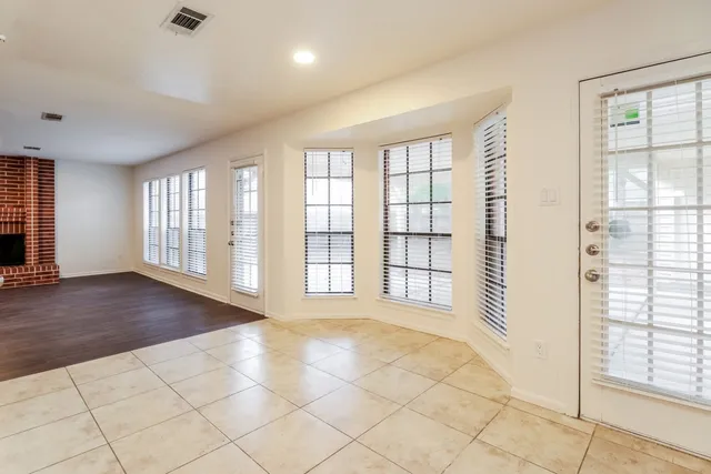 a view of an empty room with glass door