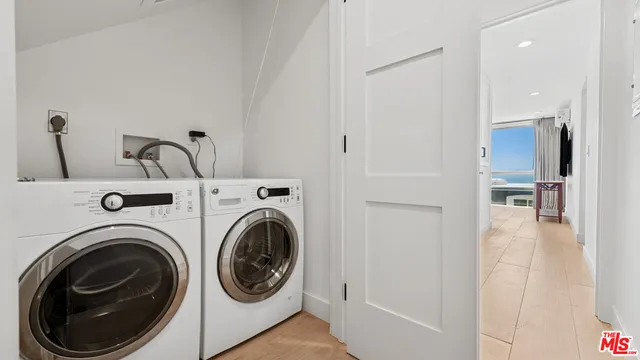 a view of a hallway with washer and dryer