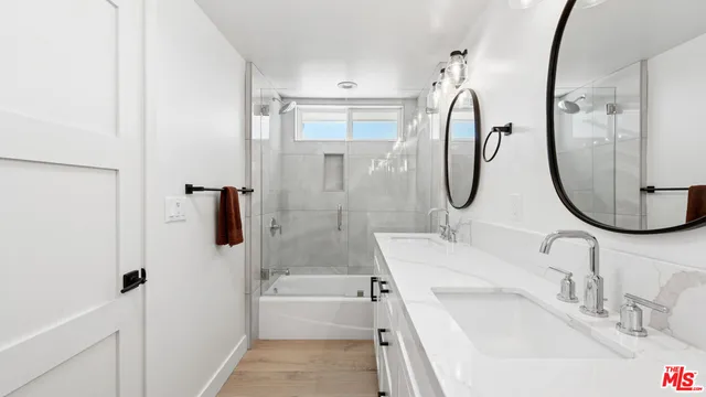 a bathroom with a sink vanity tub and a mirror