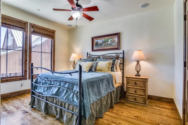 a bedroom with a bed and a dresser next to a window