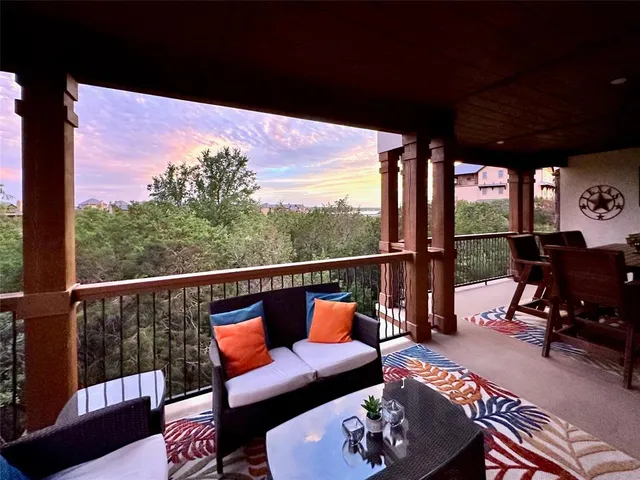 a balcony with wooden floor and outdoor seating
