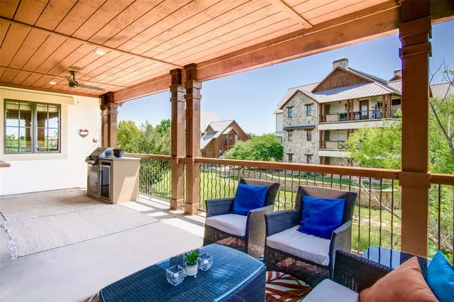 a balcony with furniture and wooden floor