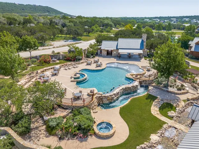 an aerial view of a swimming pool with mountain view
