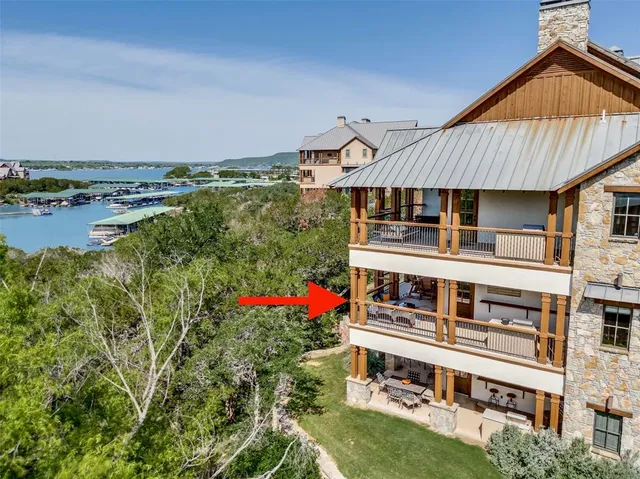 an aerial view of a house with swimming pool garden and balcony