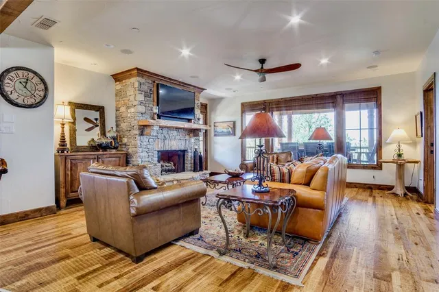 a living room with fireplace furniture and a large window
