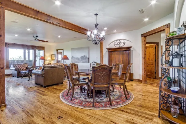 a living room with furniture a chandelier and a dining table