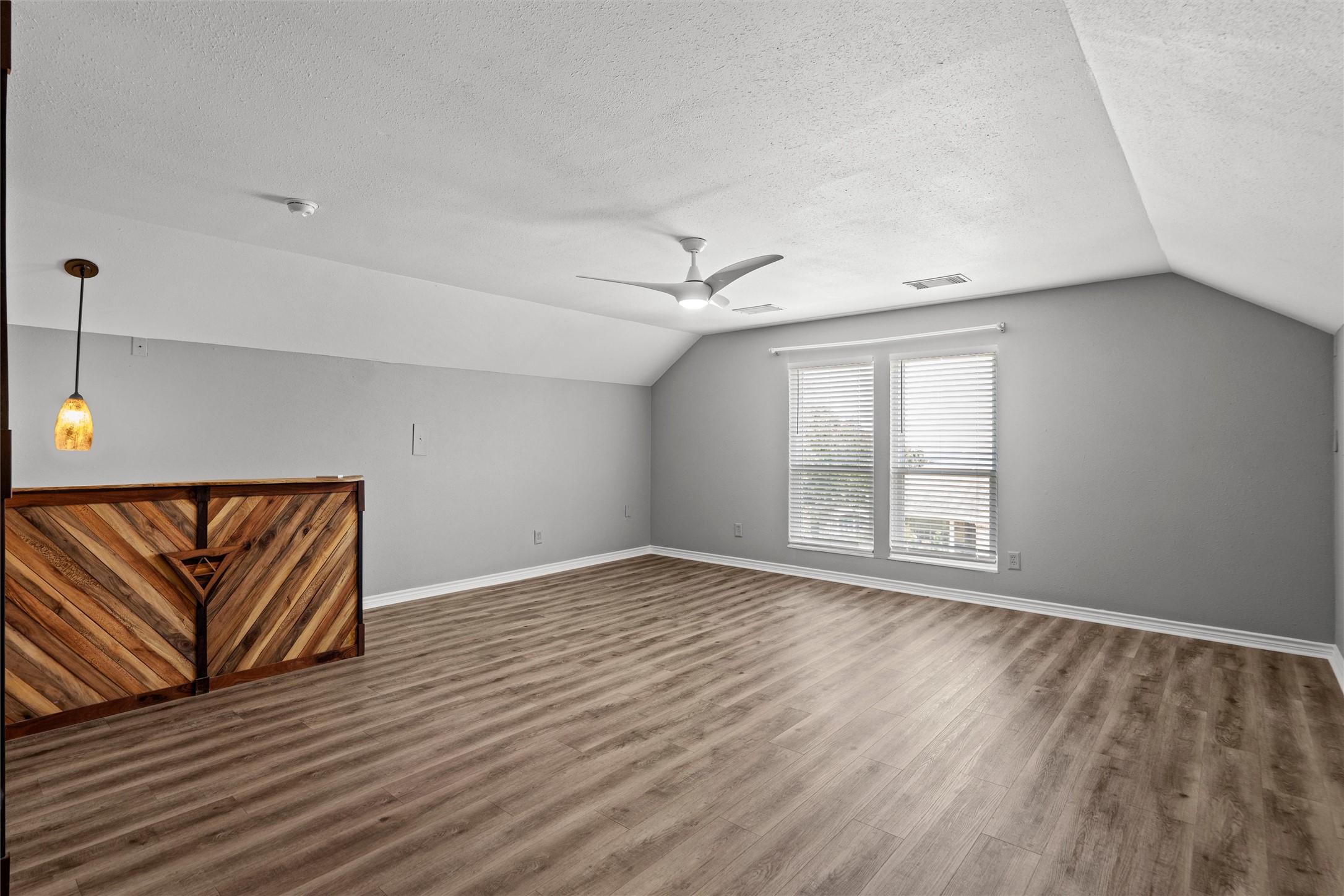 7000 Colberg Court Austin, TX 78749 - Photo 32 of 40 Bonus room/Game Room/Media Room has A spacious room offers comfortable living with a decorative half wall and rich hardwood flooring.
