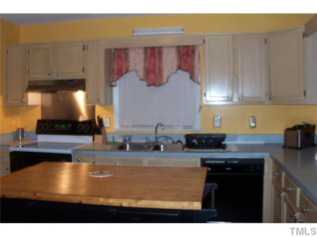 849 Cross Link Road Raleigh, NC 27610 - Photo 5 of 8 a kitchen with kitchen island granite countertop a sink a stove and a microwave oven