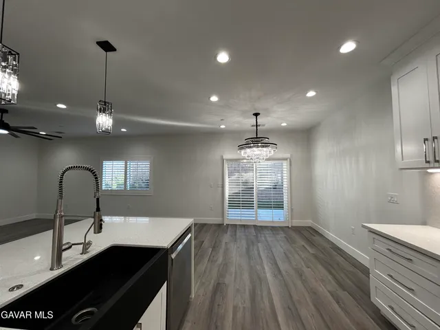 a kitchen with a sink chandelier and stove
