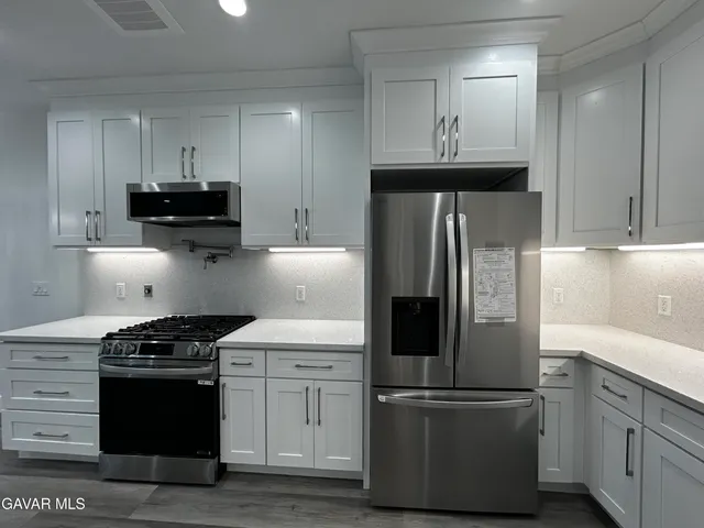 a kitchen with a refrigerator stove and sink