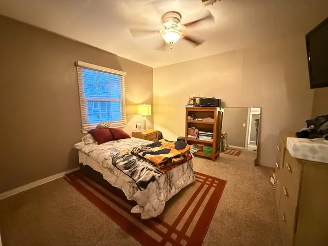 a bed room with a bed and a television