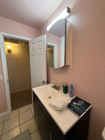a bathroom with a sink a toilet and mirror